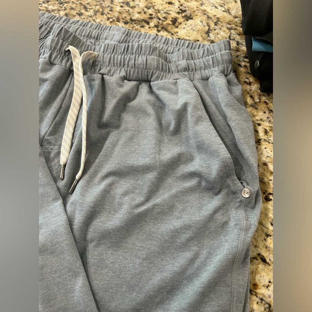 A blue/grey color Vuori sweat pants